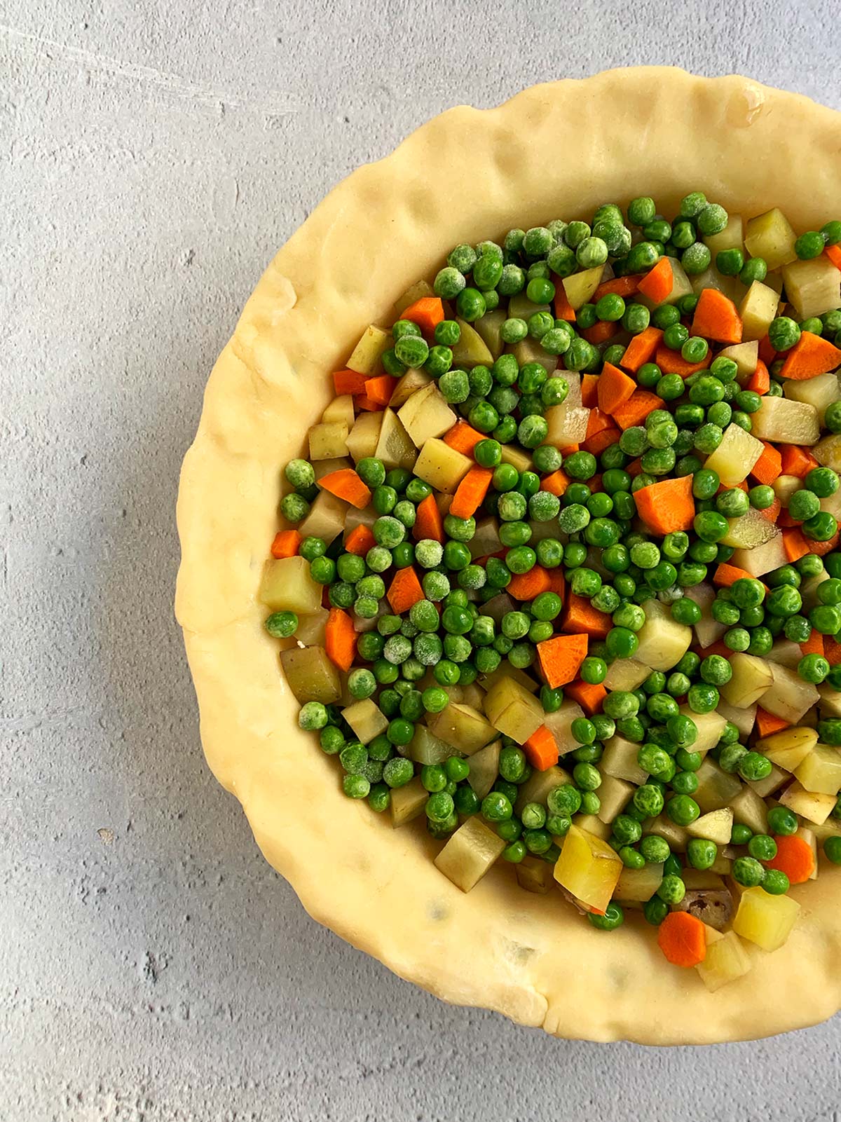 Vegetables and chicken in pie pan before adding top crust.