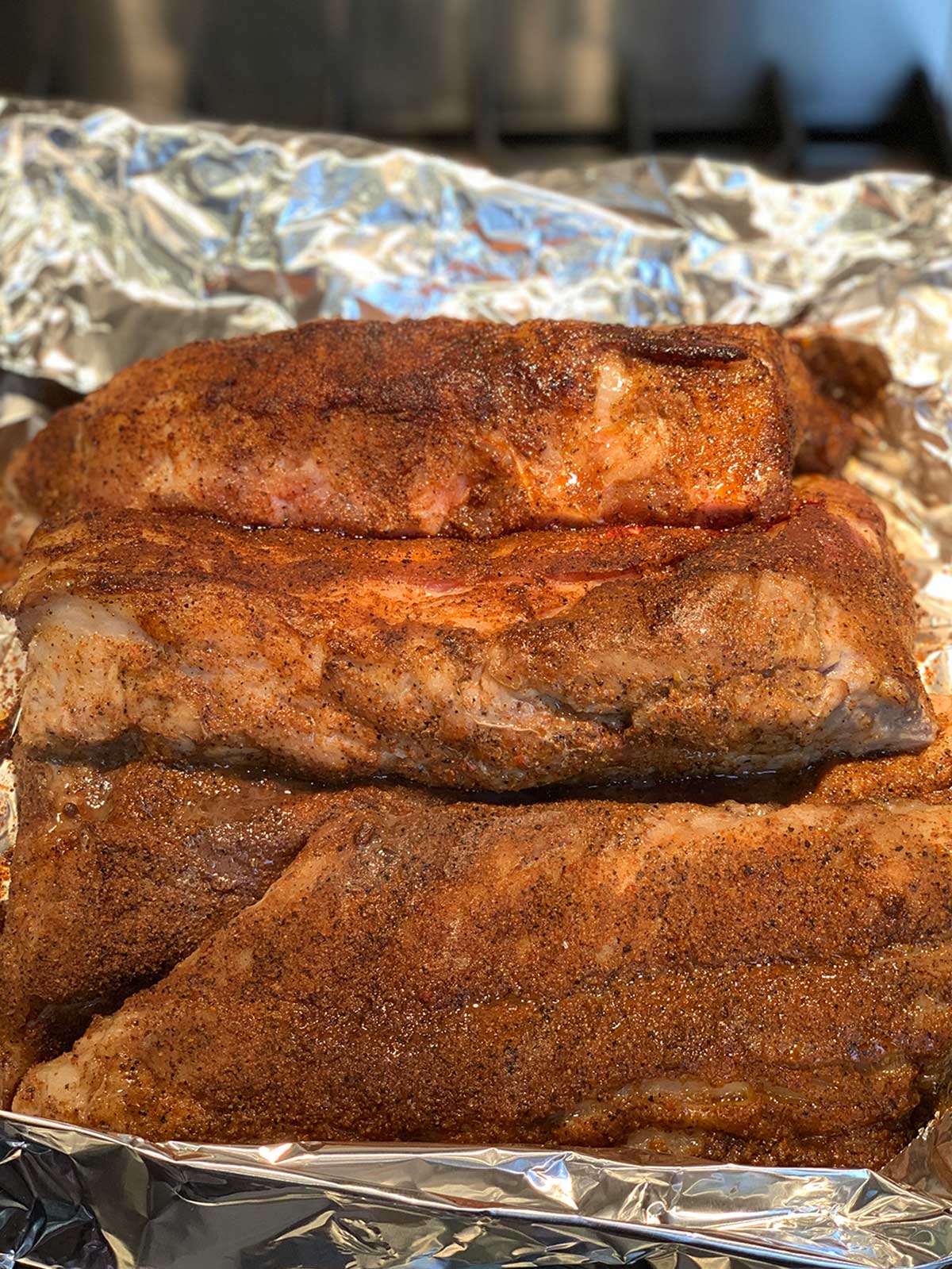 Ribs rubbed with dry spice mixture in foil wrapper.