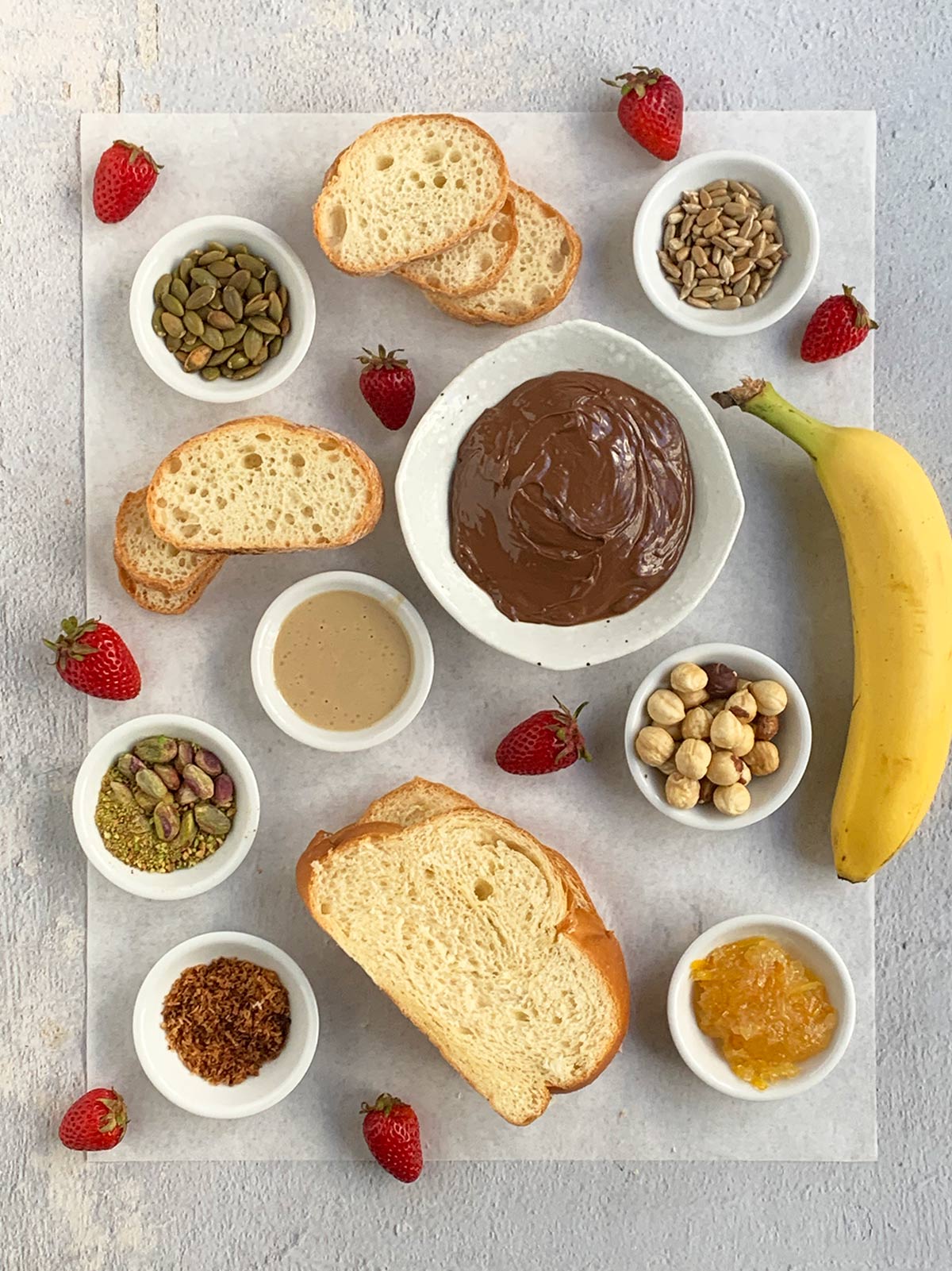 All  the ingredients for nutella toasts including mini bowls for the toppings,