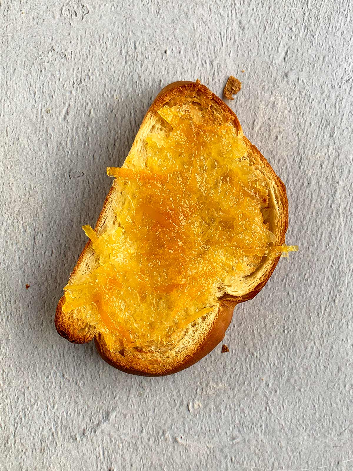 Challah bread spread with citrus marmalade.