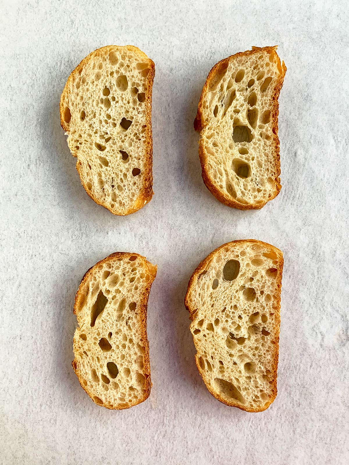 Plain mini toasts on white background, before topping.