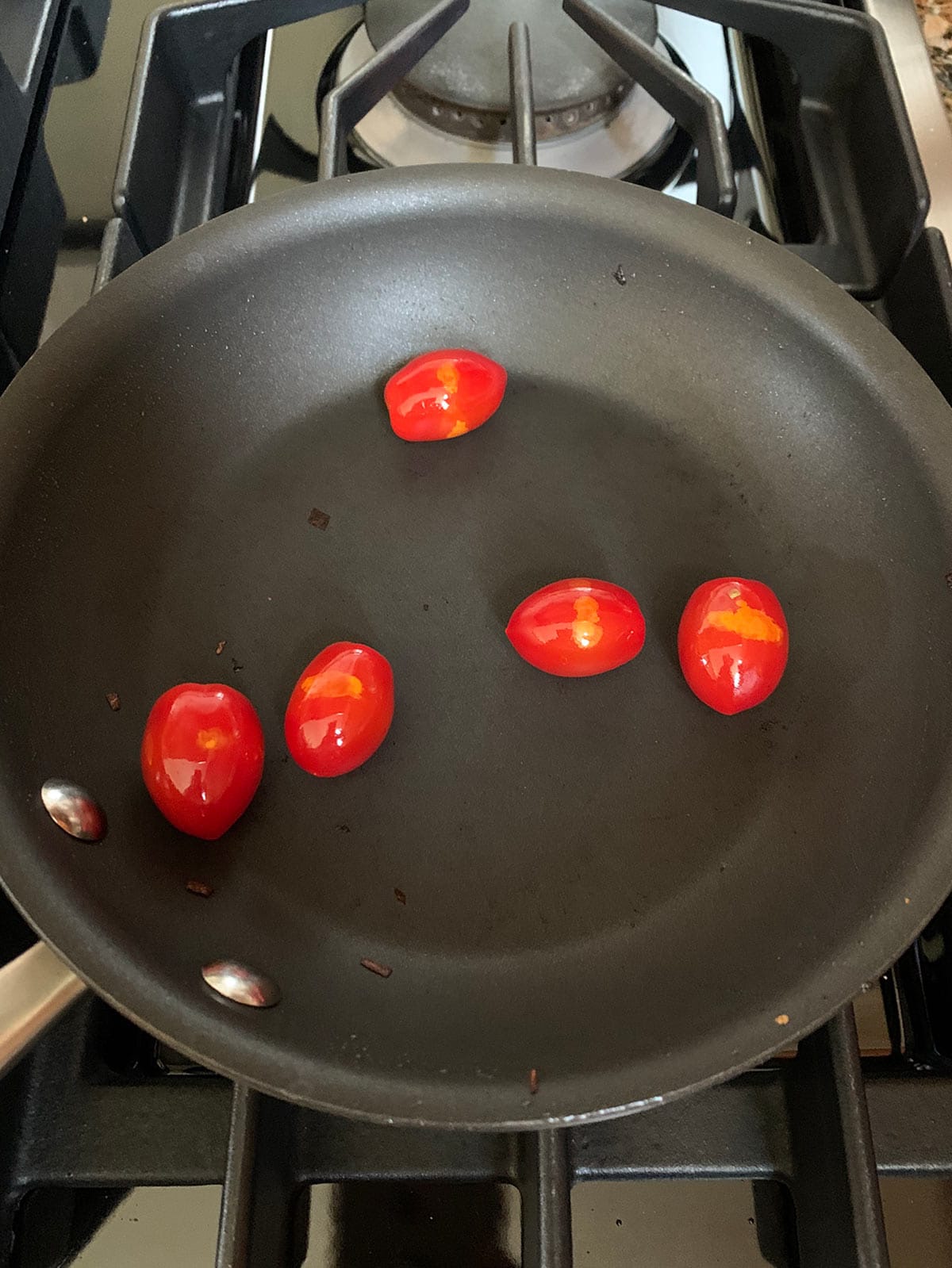 Cherry tomatoes in saute pan.