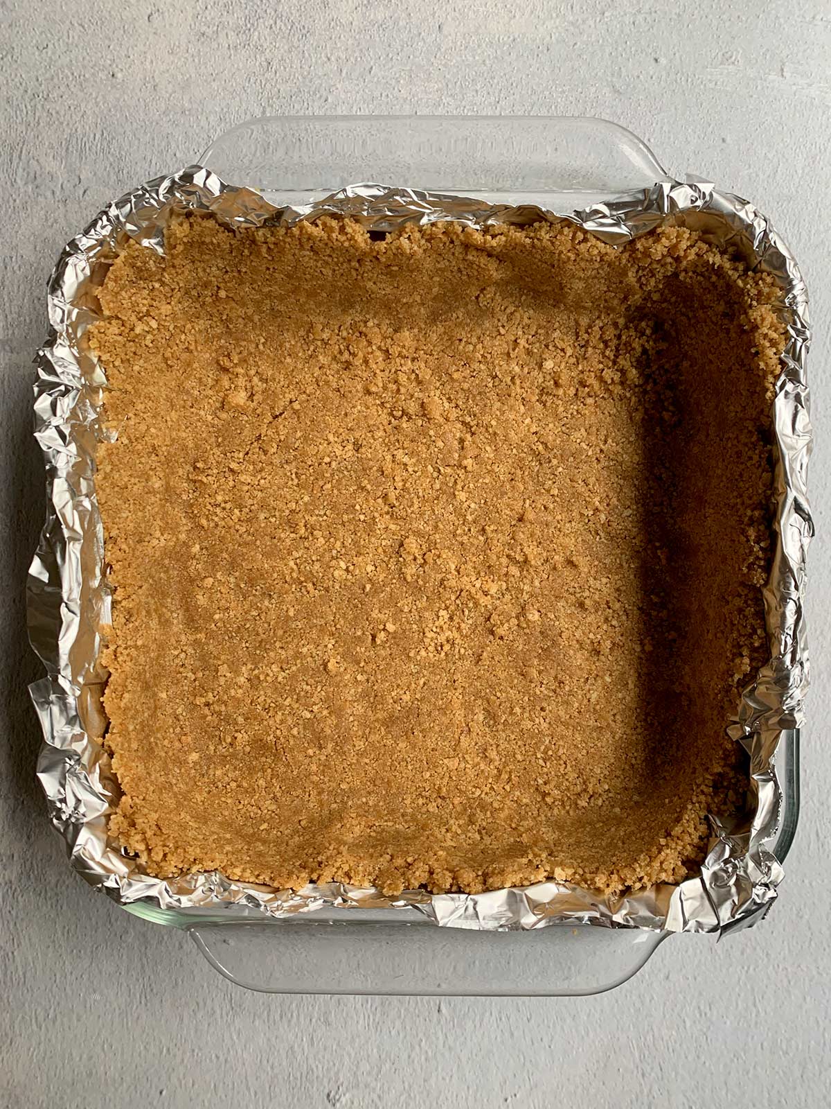 Graham cracker crust in foil-lined pan.