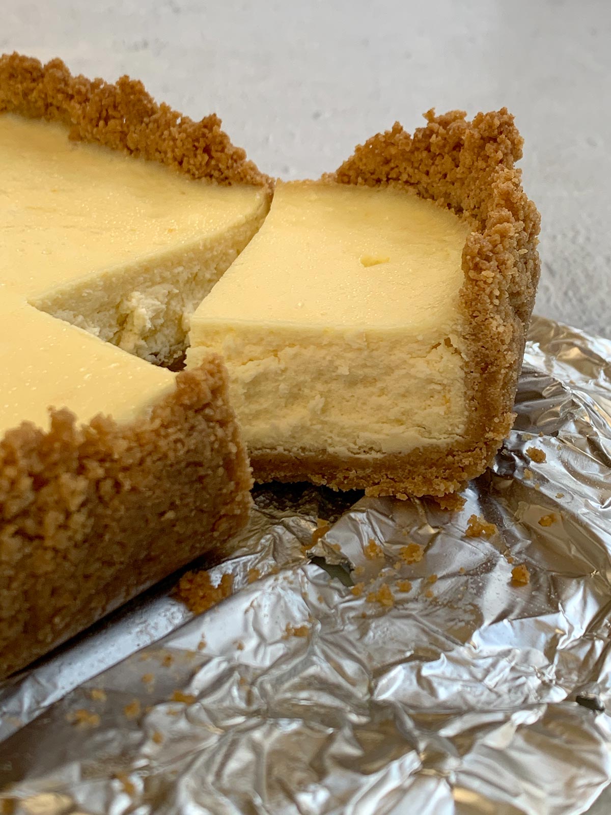 Close-up of one slice of lemon cheesecake cut from the chilled cheesecake pan.