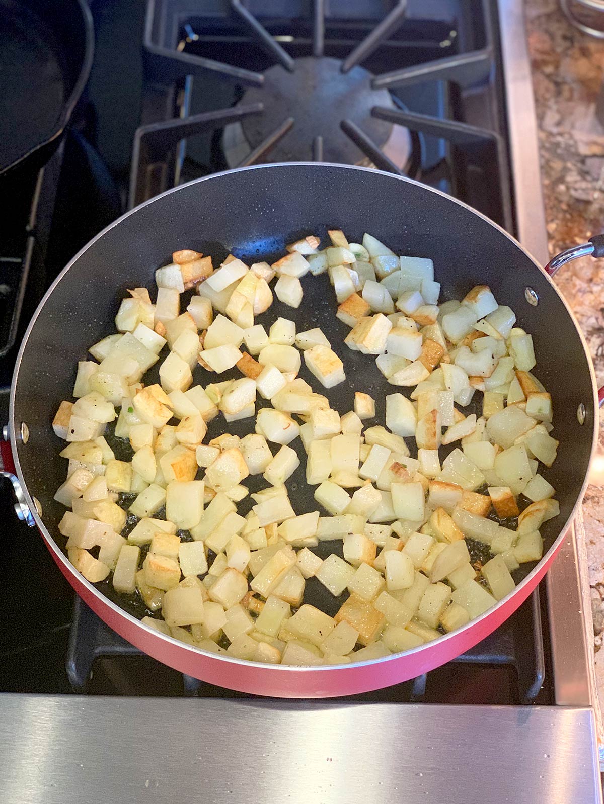 Potatoes browning in saute pan.