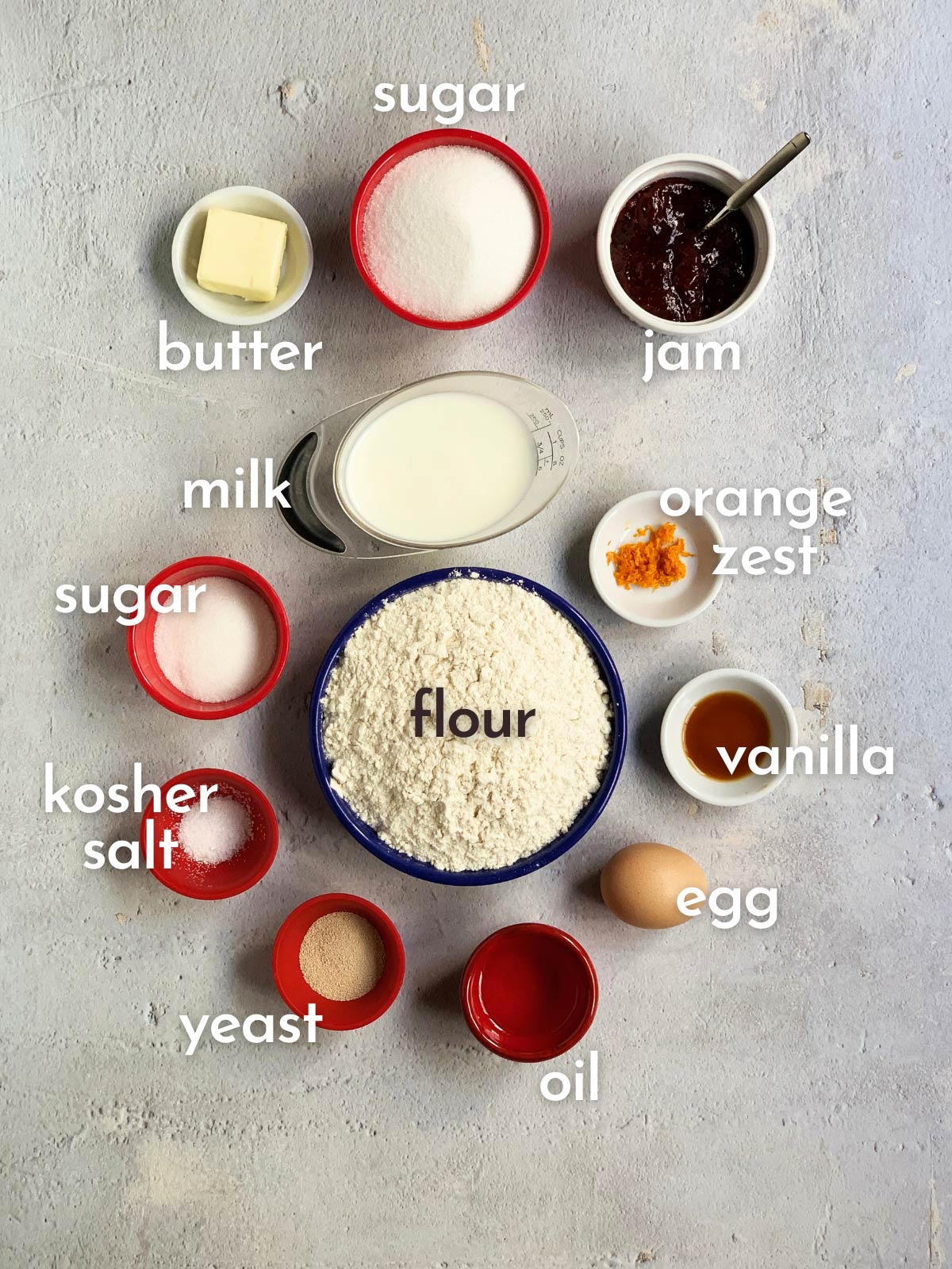 Ingredient shot with everything you need to make jelly filled donuts labeled with their names.