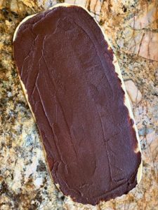 Chocolate filling spread on babka dough.