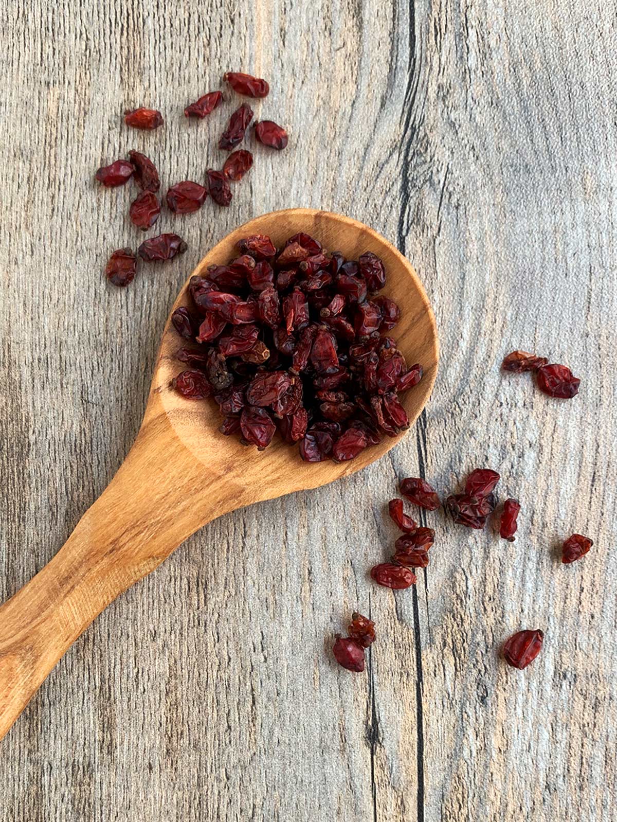 Barberries on a wooden spoon.