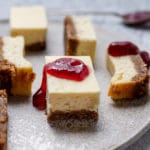 Close up of a cheesecake bar with jam on it.