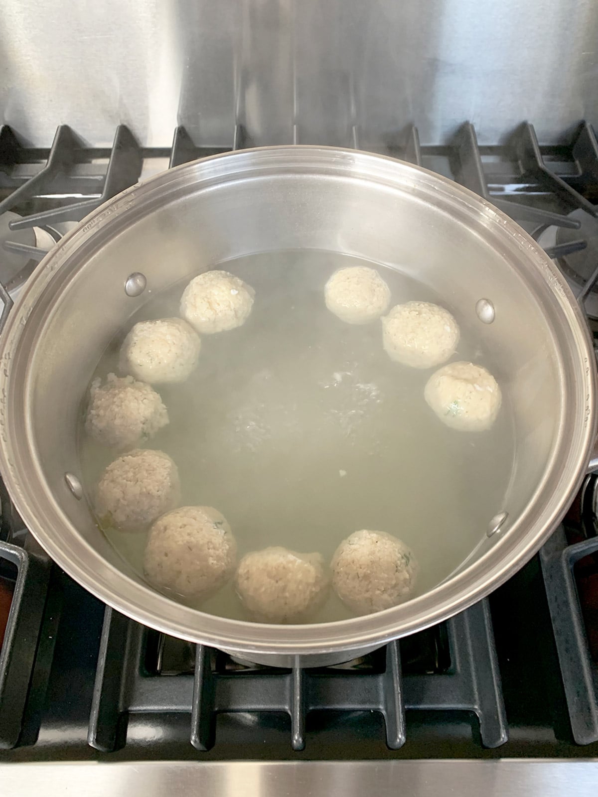 Matzo ball pot uncovered with balls ready to check for doneness.