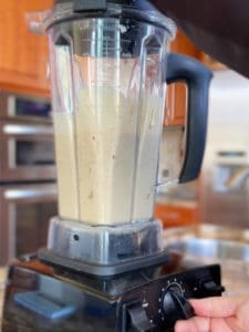 Side view of blender with smoothie in it.
