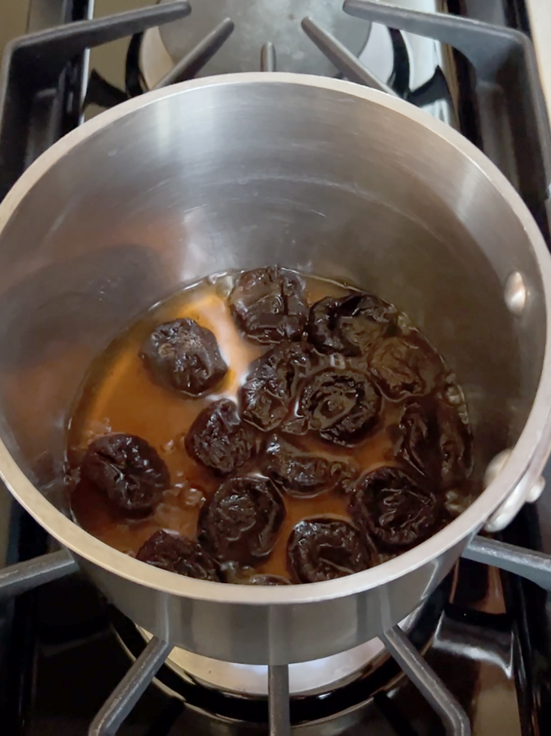 Prunes simmering in the pot.