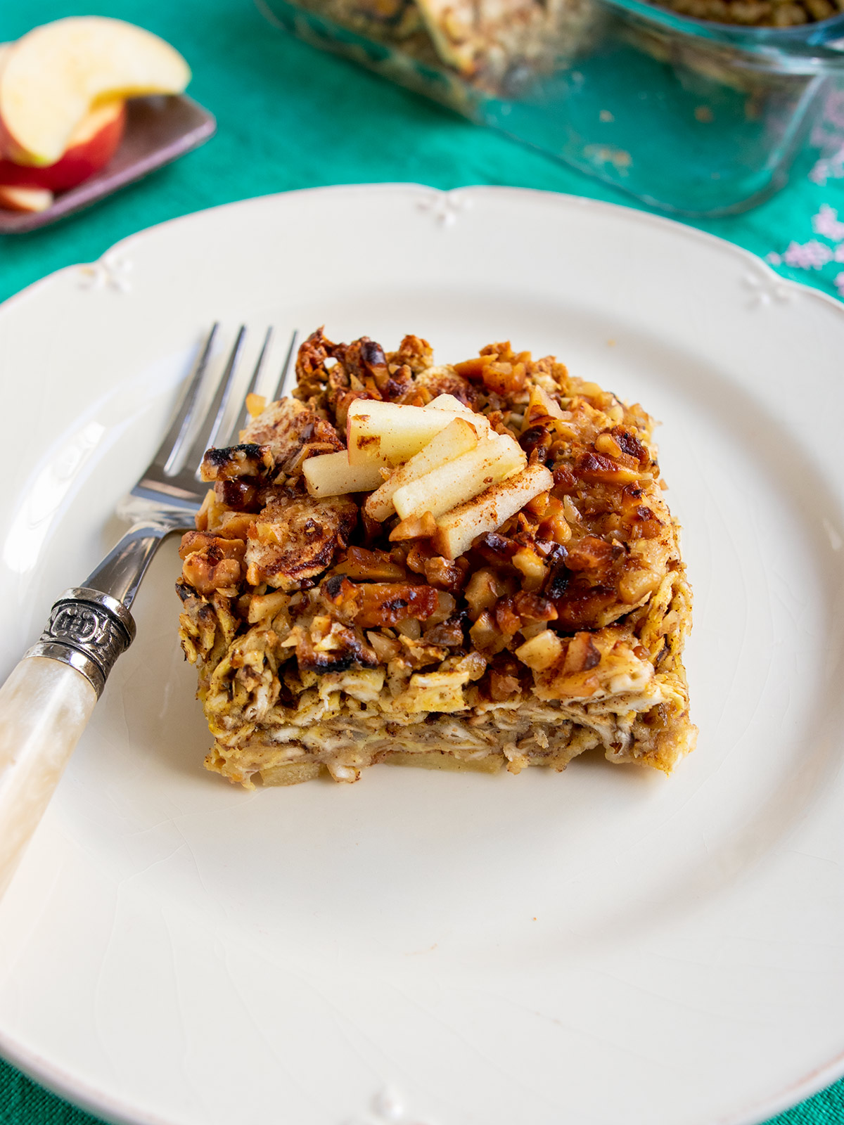 Close up of one piece of kugel on a white plate with a fork.