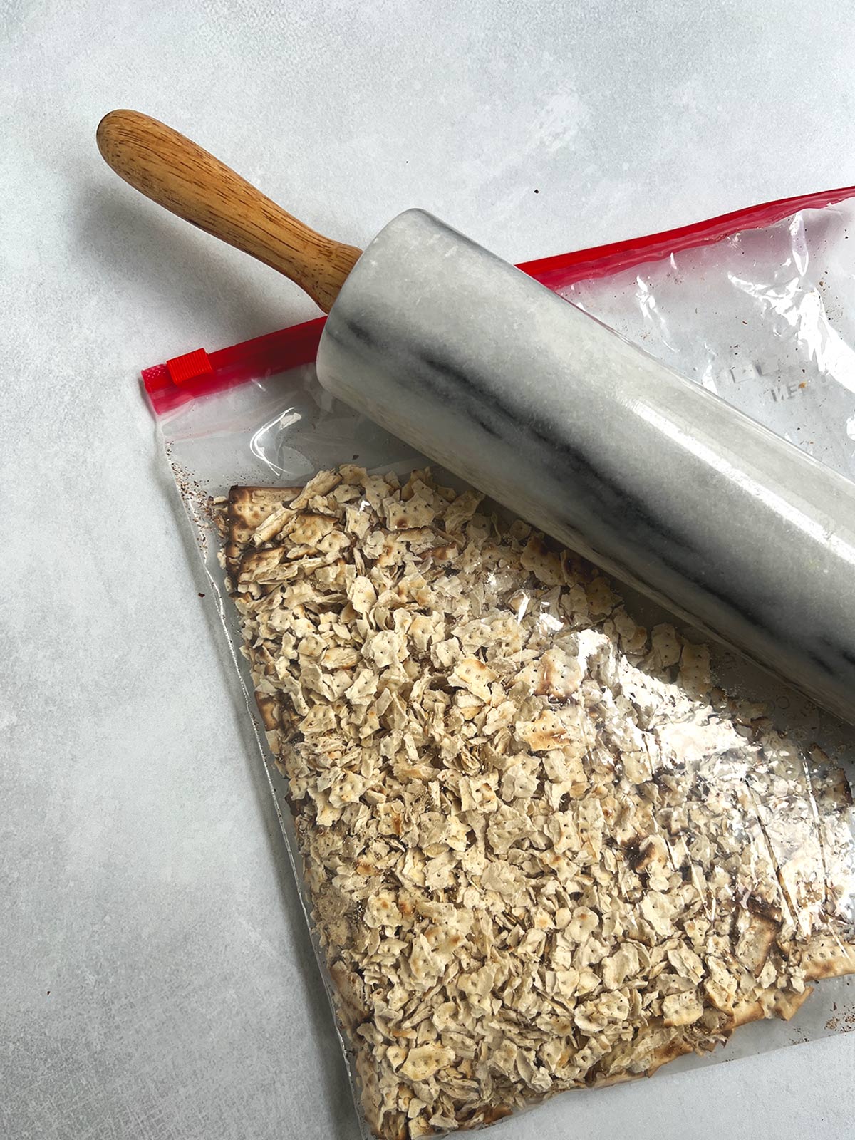 Matzo crushed by a rolling pin in a plastic bag.