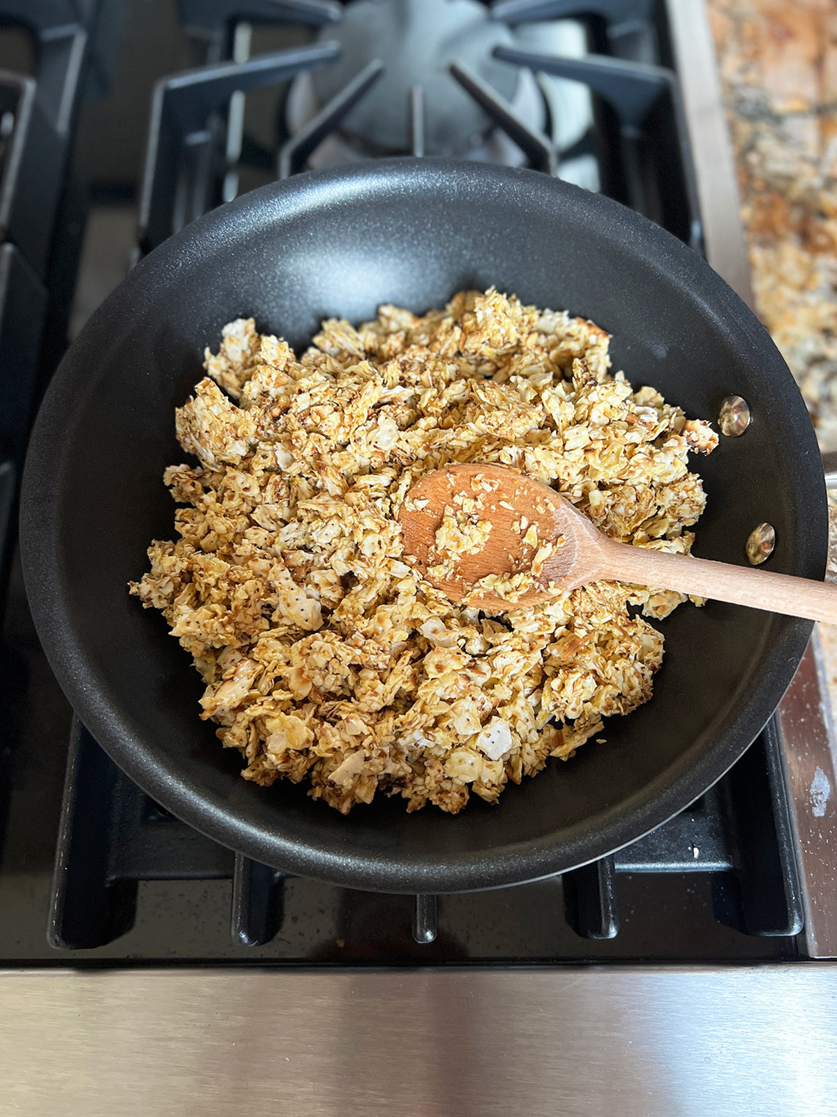 Matzo farfel and eggs in saute pan on stove.