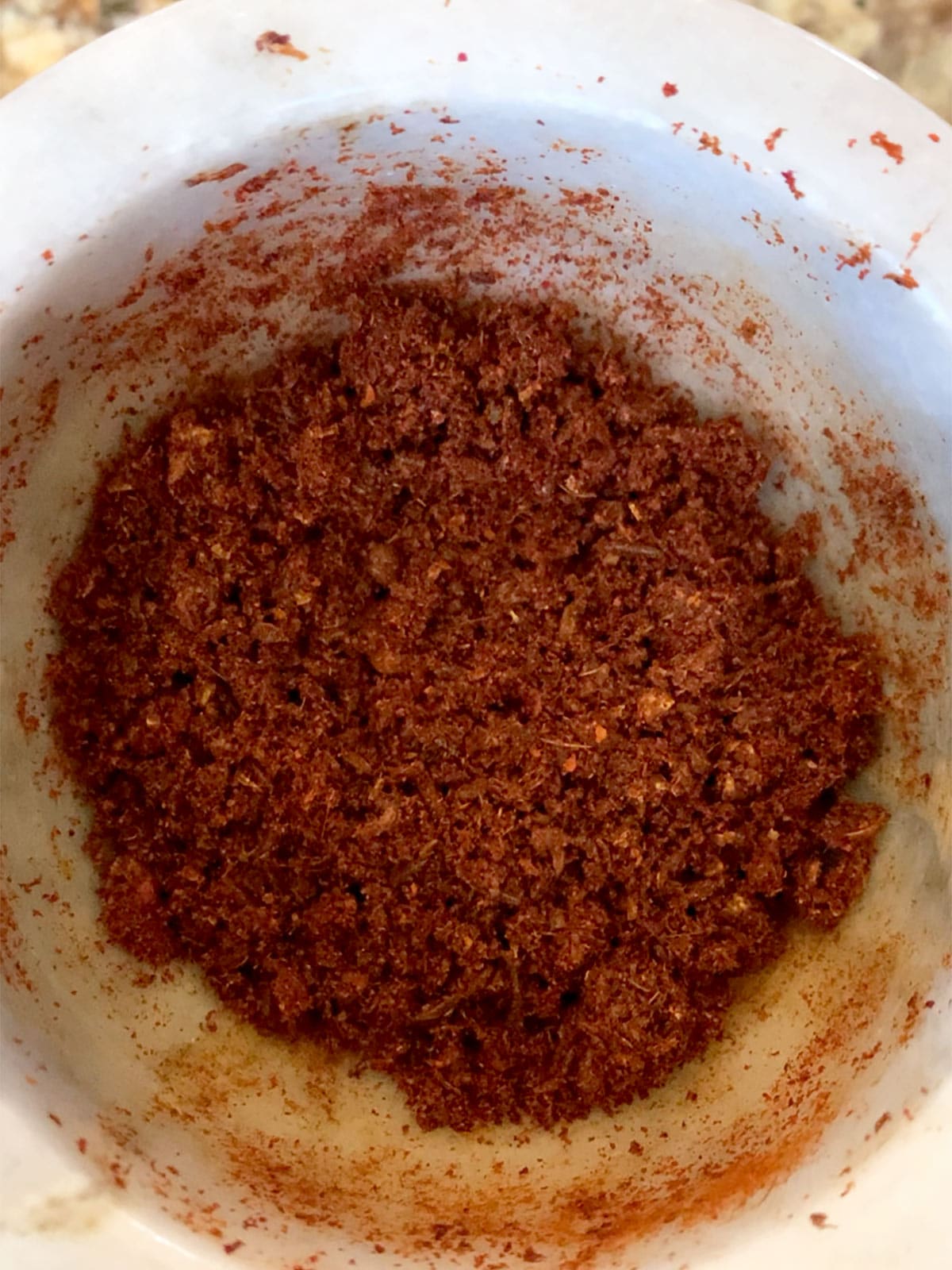 Dried spices for rose harissa combined with rose petals and smoked paprika.
