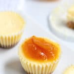 Pinterest image for cheesecake bites showing marmalade on top of one of the bites.