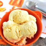 Bowl of no churn ice cream in an orange bowl.