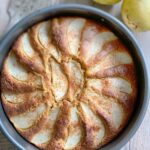 Pear cake baked in a round pan and ready to serve.