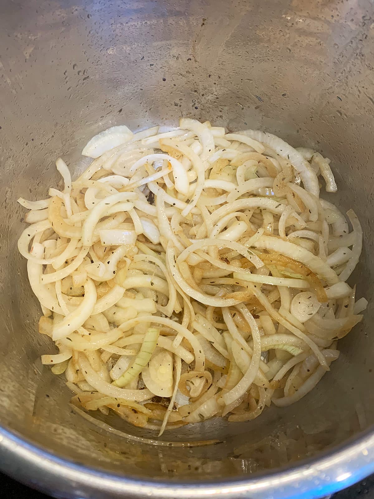Onions for pressure cooker pomegranate brisket sauteing in the instant pot.