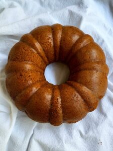 Honey cake removed from Bundt pan and placed on a white tea towel.