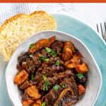 Pinterest image showing a bowl of brisket with a slice of challah on the side.