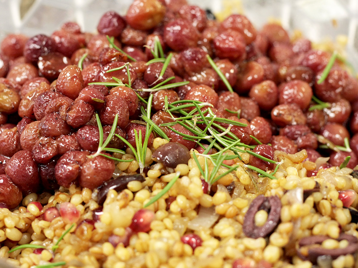 Roasted grapes in a wheat berry salad with rosemary on top.