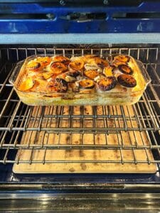 Roasting pan of chicken in the oven.
