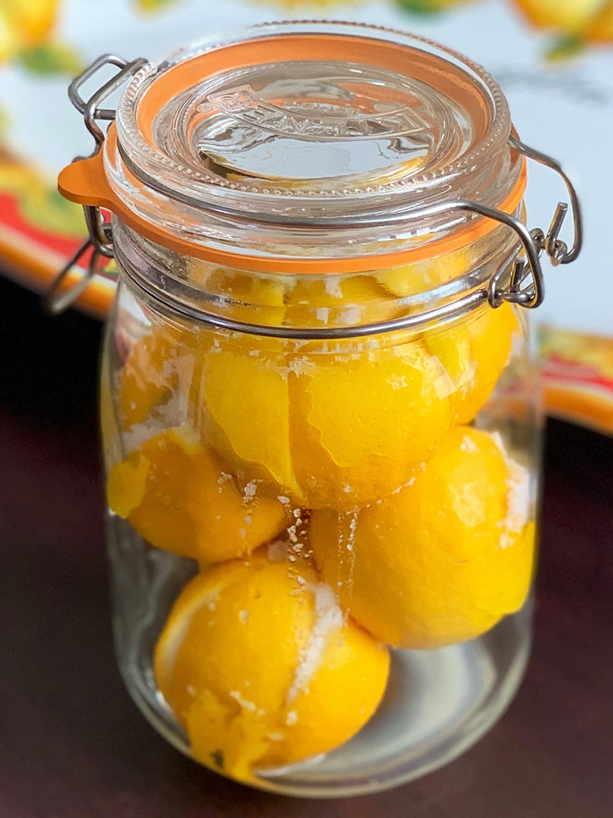 Fresh lemons with salt added and placed in a jar to start the preserving process.