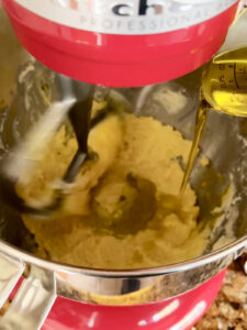 Slowly drizzling in olive oil to dough in stand mixer for the shortbread cookies.
