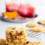 Pinterest image with a stack of cookies and two cocktails showing in the image.