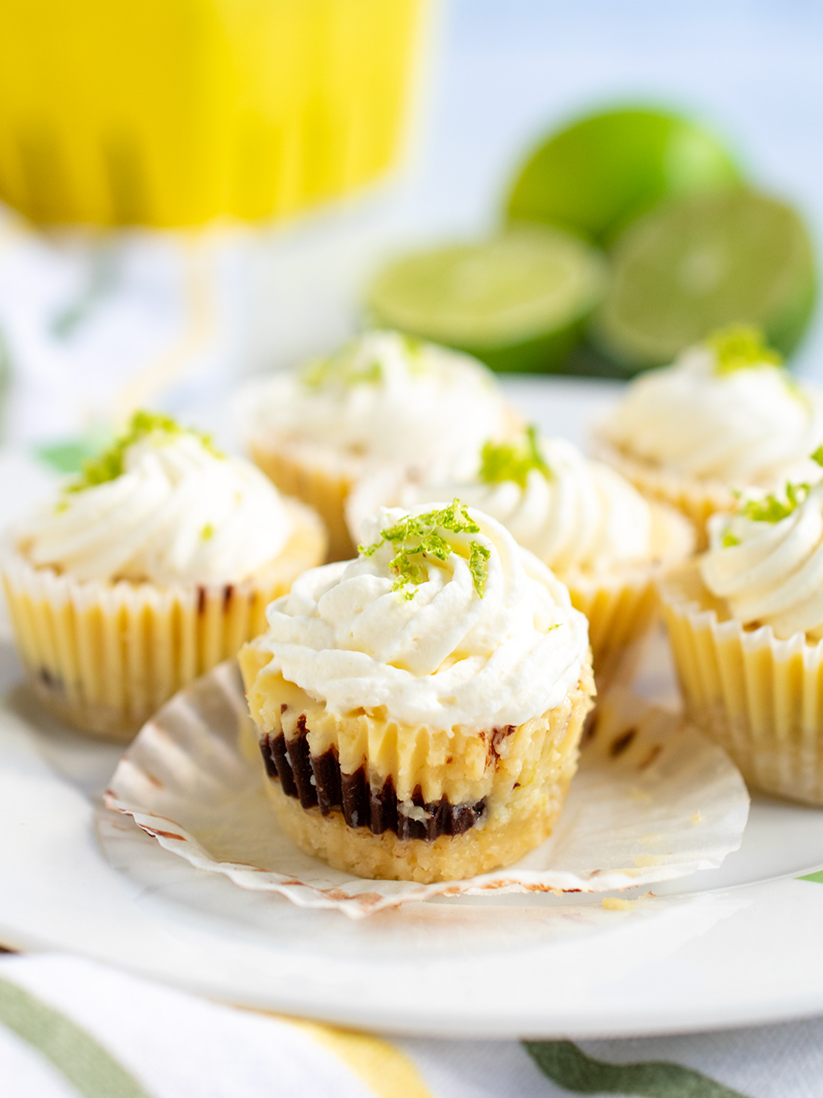 Close up side view of a mini key lime pie showing the chocolate layer.