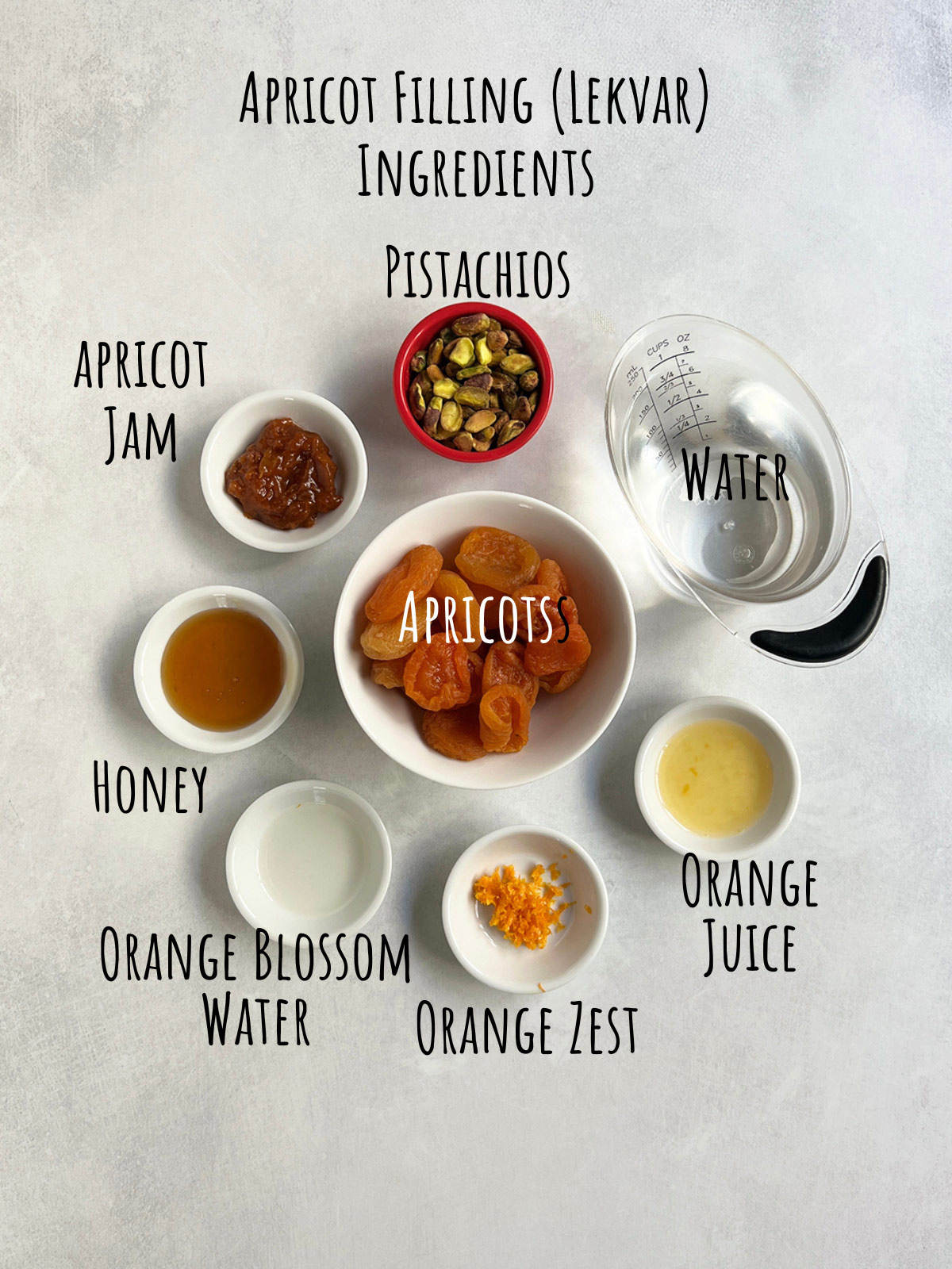 Ingredient shot for apricot lekvar showing apricots in the center with other flavorings circling it.