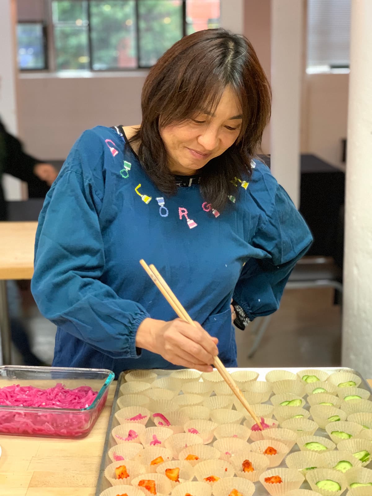 Beth's friend preparing banchan to go with the Jew Mandu for an event.
